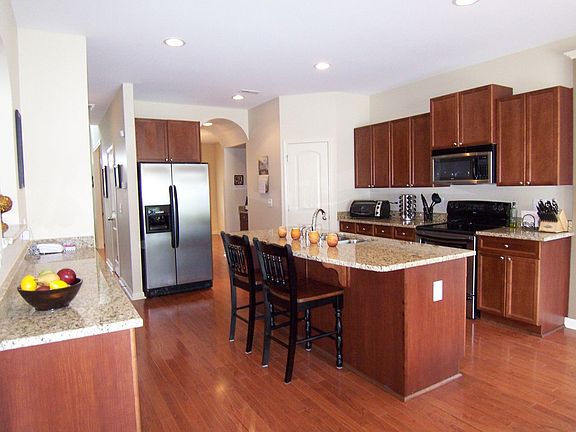 Desiger Kitchen: granite, stainless, hardwood, many maple cabinets.