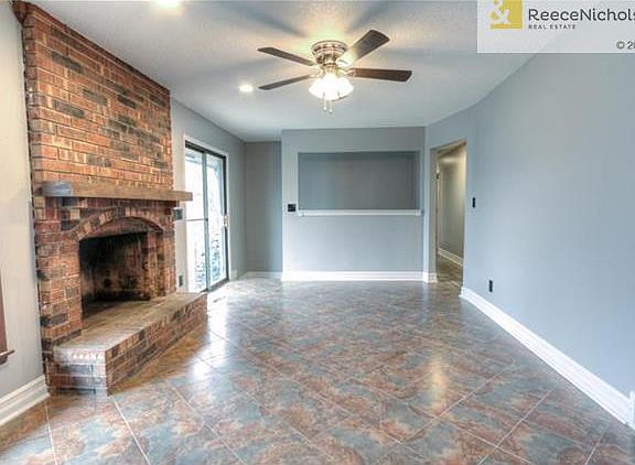 living area just off kitchen features gorgeous fireplace