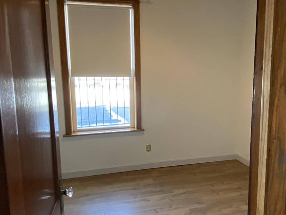 Bedroom #3 near kitchen. 11'9 x 9'8" closet and window looking South over flat roof.