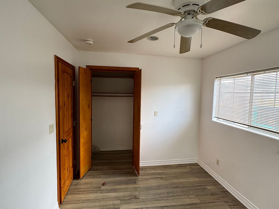 Bedroom with ceiling fan showing the closet as well.