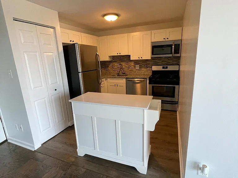 Updated kitchen with modernized appliances and island.