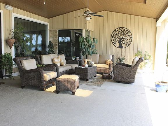 Look at this huge outdoor seating area! 3 ceiling fans to help keep things cool and incredible water views!