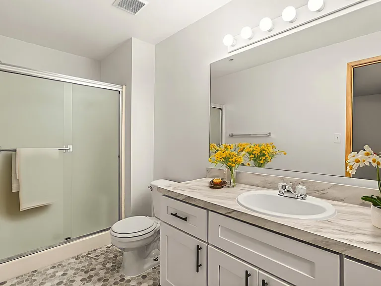 Bright and refreshed bathroom, virtually staged with modern finishes, marble-style counters, and cheerful decor. Bright and refreshed bathroom, virtually staged with modern finishes, marble-style counters, and cheerful decor.
