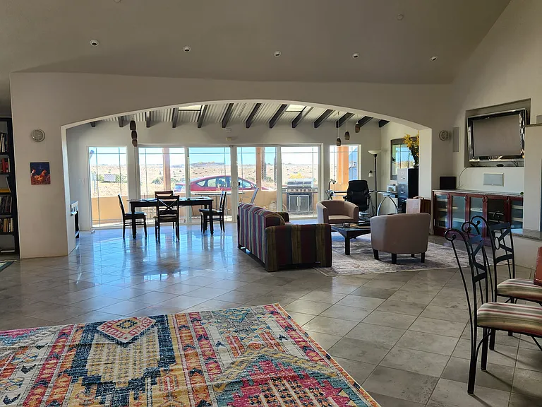 Taken from just inside the front door. The wall of windows and patio doors now have curtains.