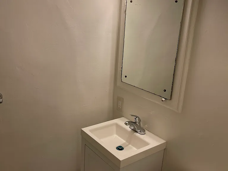 Bathroom has newer vanity sink, lighting and a tub/shower combo