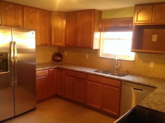 Beautifully remodeled Kitchen : new wood cabinets, granite counter tops, ceramic tile floors, and ne