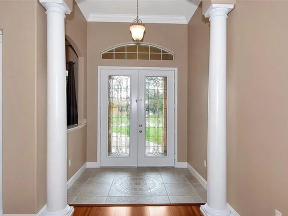 Double French Doors offer enhanced natural light, and indoor out door transition. A charming vestibule that acts as a functional entry landing pad.