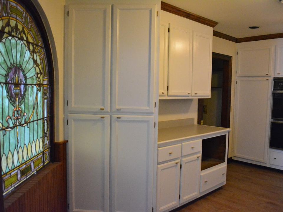 Newly painted kitchen cabinets, also with unique stained gla