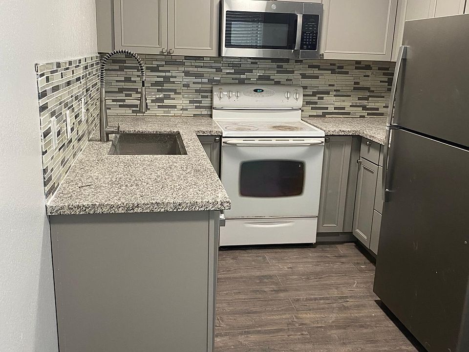 Granite countertop, tile back splach, stainless steel sink.