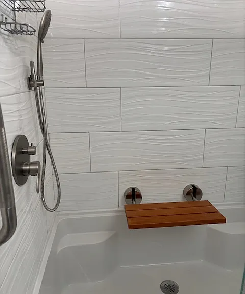 LARGE or oversized walk in shower with rain shower head and corded nozzle. Bench and grab bars for comfort and safety.