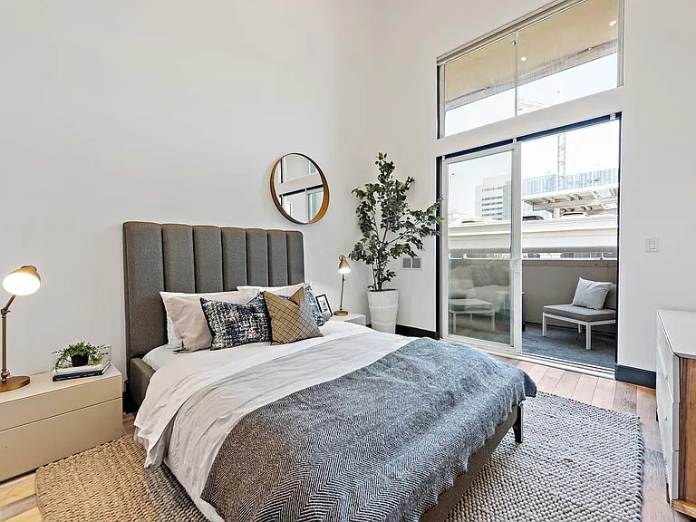 master bedroom w/ private patio. Vaulted ceilings (20ft) w/ recessed dimmable lighting.