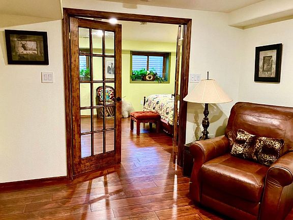 French Doors entrance to bedroom with large closet, dresser & King size bed.