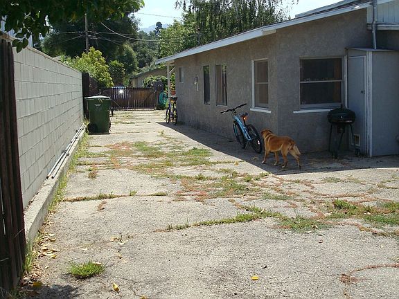 Side driveway allows multiple vehicle off-street parking + backyard access.