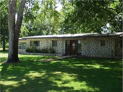 Exterior Front : This tree lined yard has a great view of the la
