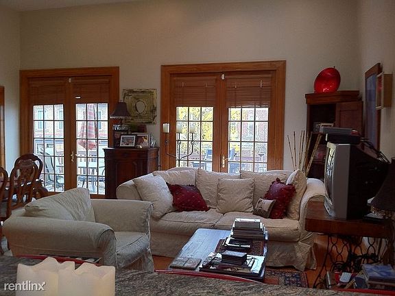 Open format living room features 2 pair of French-style door