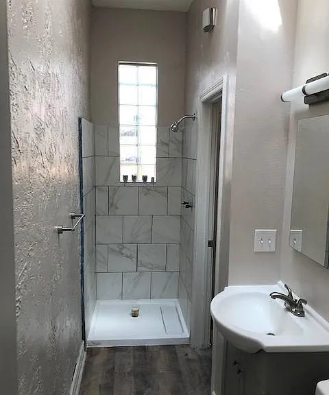 Bathroom with glass block window in shower