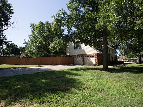 Over-sized, side-load 2-car garage includes storage closet, peg board, shelving, pedestrian door to backyard, sidewalk to back patio and large flat driveway ideal for sports court!