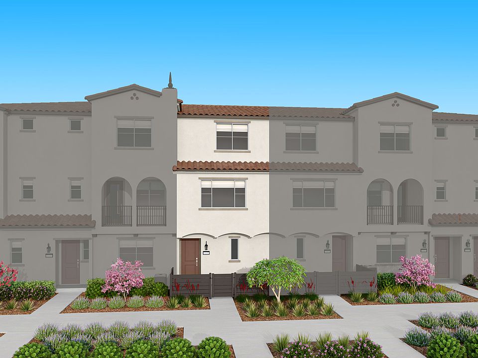 A multi-story residential building with a Mediterranean-style architecture, surrounded by a well-man