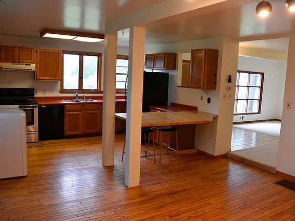 Kitchen viewed from dining room; opens to living room to right.