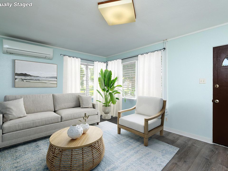 Spacious living room with many louvers for natural light and breeze.