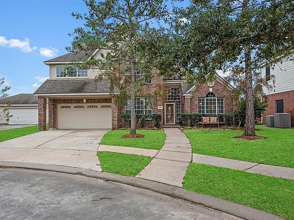 The red brick and beige trim make for a lovely elevation.