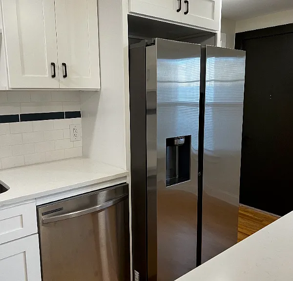 Beautiful kitchen with gas stove, mounted microwave, and dishwasher.