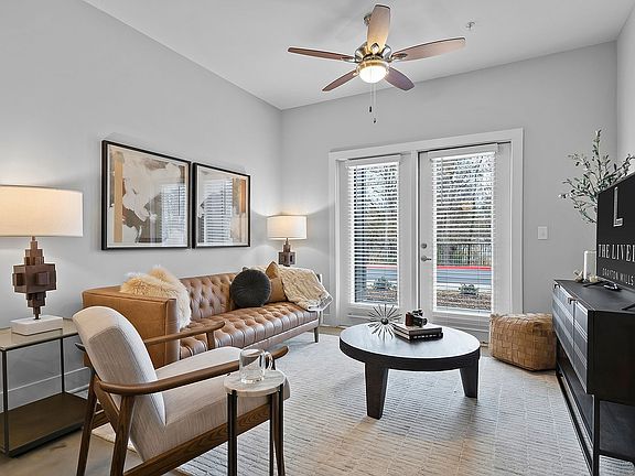 Spacious living room with ceiling fan