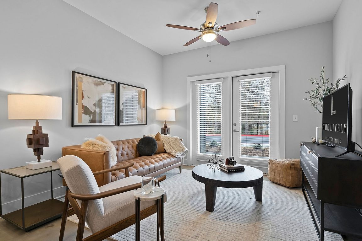 Spacious living room with ceiling fan