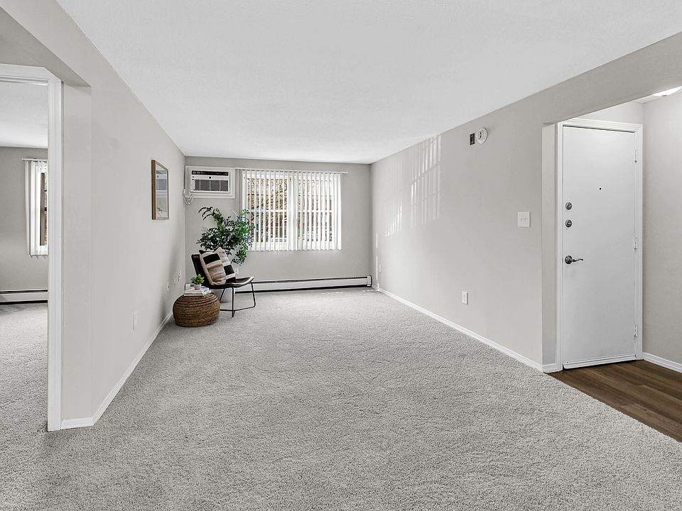 Unwind in your cozy living room with plush carpeting and large windows, your haven for relaxation.