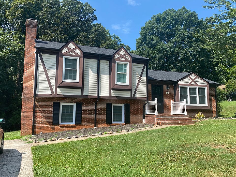 Tutor style split level house with brick and vinyl siding and a new roof