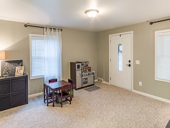Large living room  completely updated.  Lots of options for setting this room up this side could have a dining room table,  piano, or a reading area.