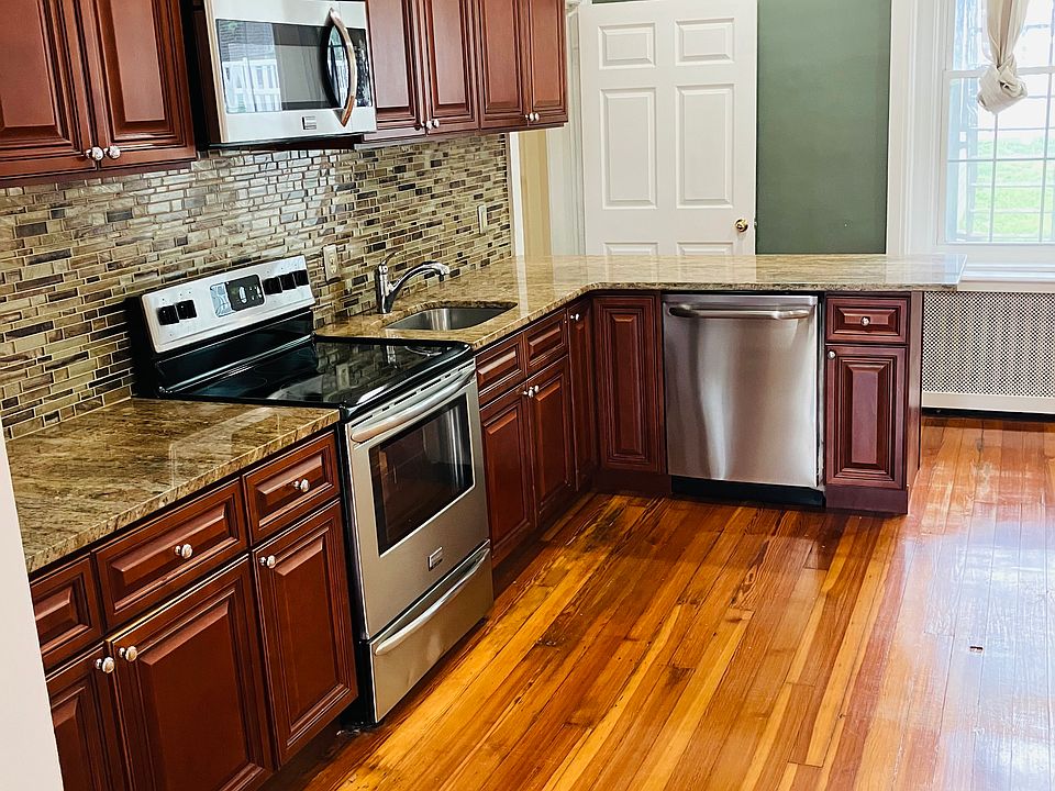 Kitchen with dishwasher. Hardwood floors throughout.