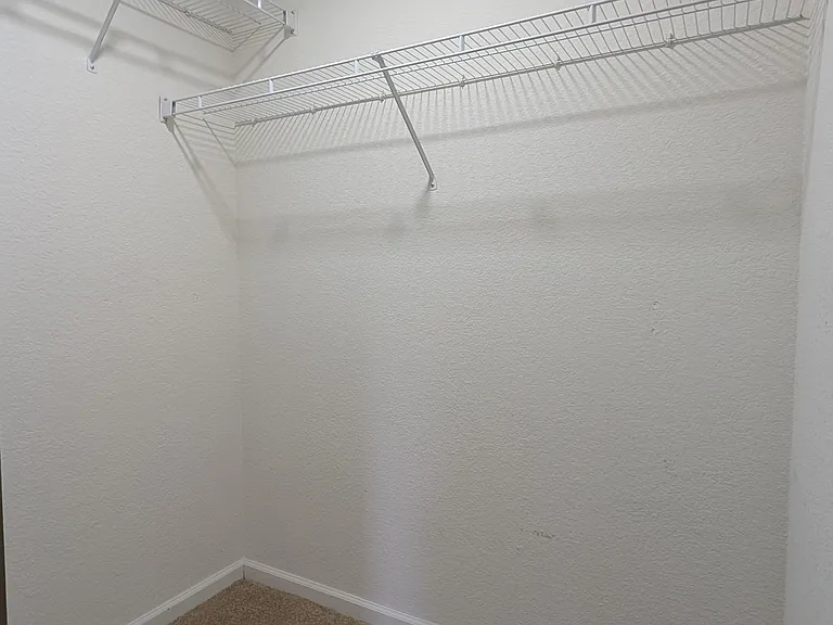 Walk-in closet in secondary bedroom