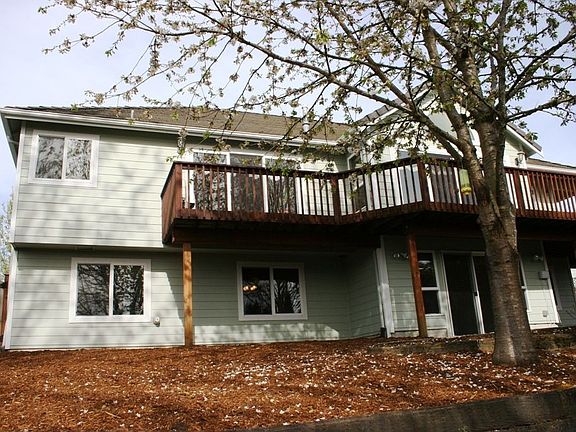 View of backof home and big deck