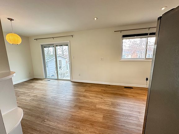 The open kitchen and dining space with a sliding door to the back yard. The sliding glass door features a built in blind for convenience and privacy.