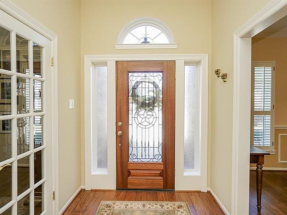 Beautiful lead glass front door greets you as you enter. Formal dining room is to the left of entry (right in this photo) and the study/home office is behind the french doors