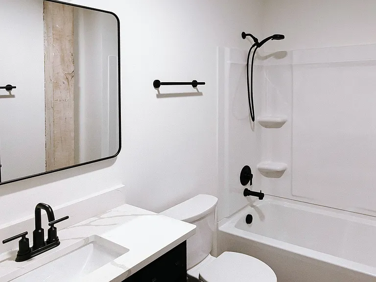 Second bathroom features vanity and bath/shower tub combo.