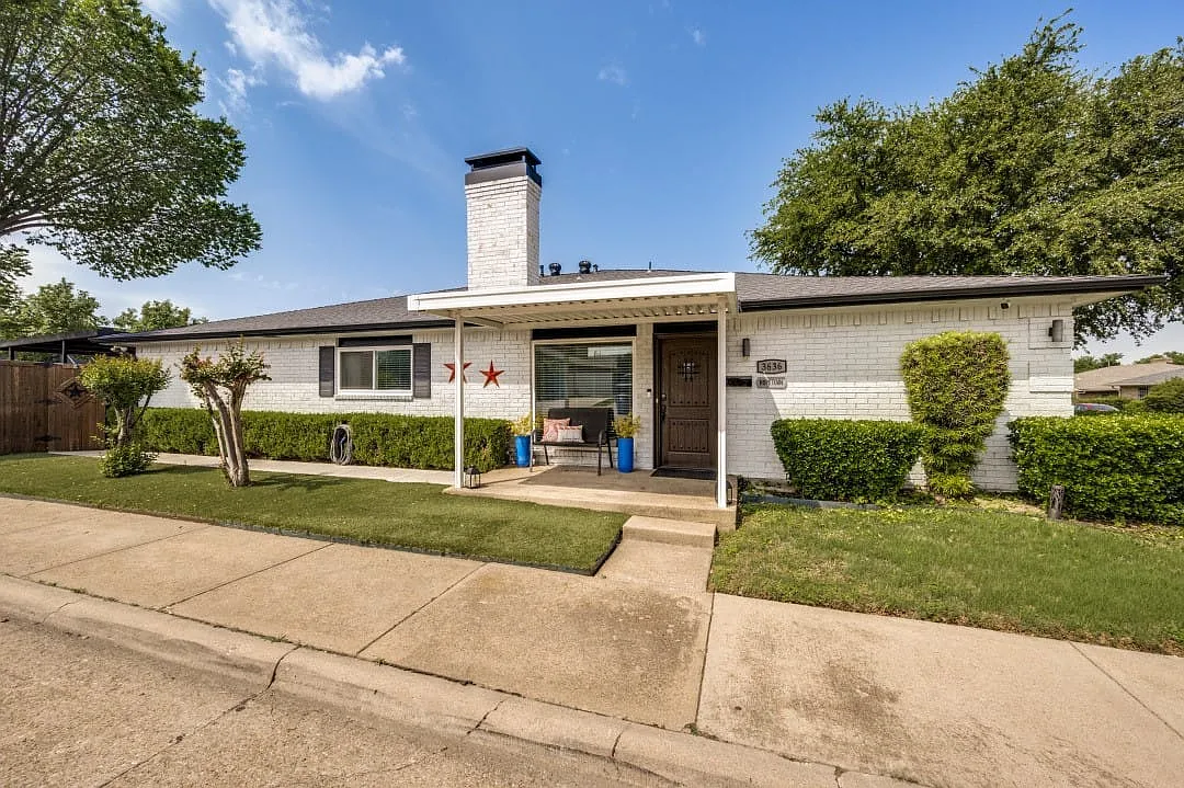 White brick exterior with a dark shingled roof and a covered entryway - 3636 Hopetown Dr