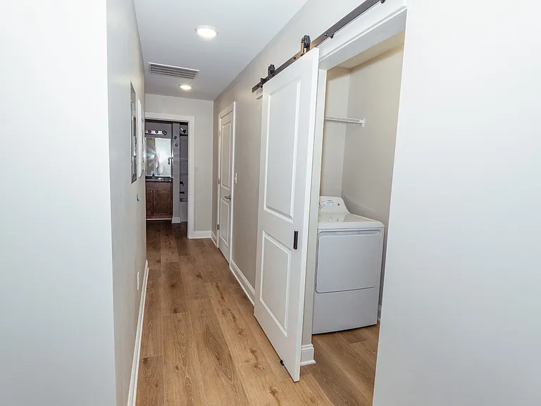 Hallway with sliding barn door laundry room with your bathroom at the end of the hallway.
