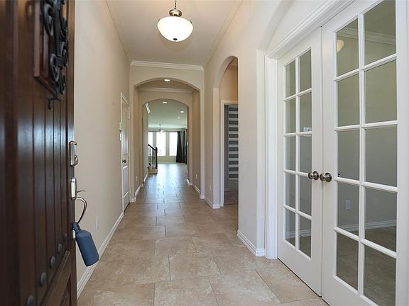 Entrance Of The Home To Extensive Tile Floors*Double French Doors Lead To Study.