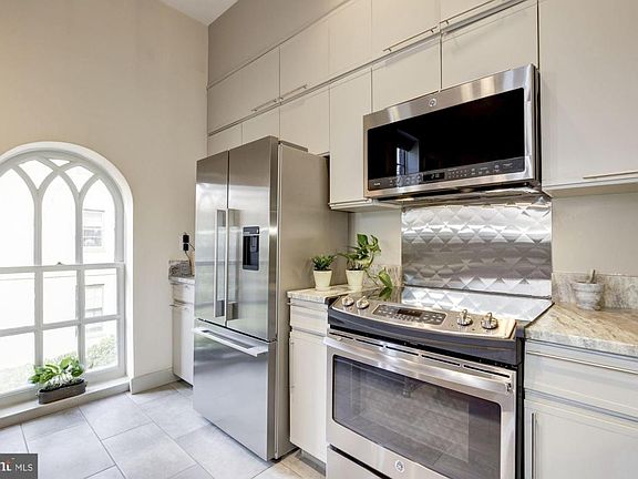 Kitchen with stainless appliances and granite counters.