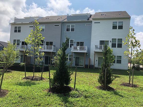 Back of home showing top deck loft. Light Blue siding.