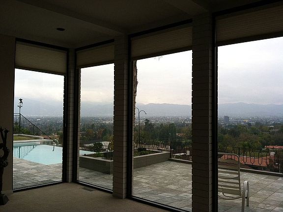 10' high windows overlook the patio and city below
