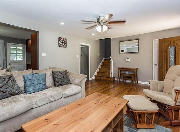 Exposed hardwood floors & neutral paint in liv rm