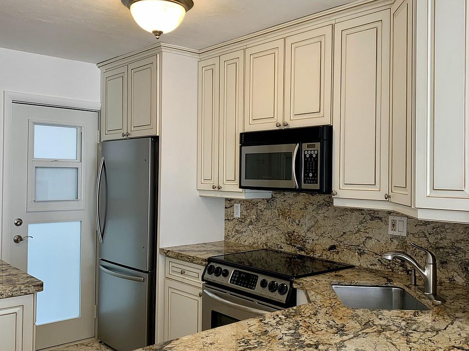 raised ceilings in open kitchen with abundant cabinet storage, new refrigerator