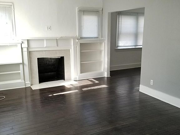 View of the living room with fireplace and shelving