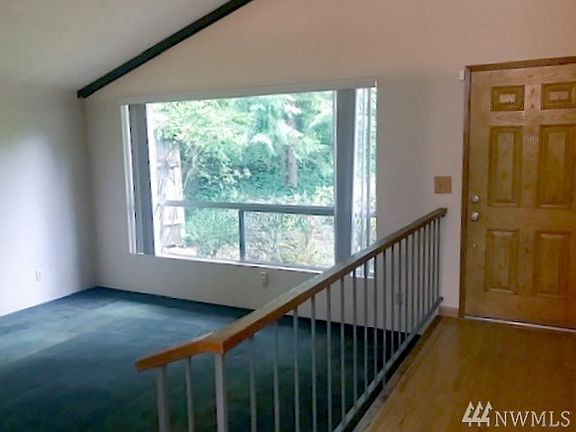 As you enter the home you'll find a spacious entry and living room with vaulted ceilings and a large picture window.