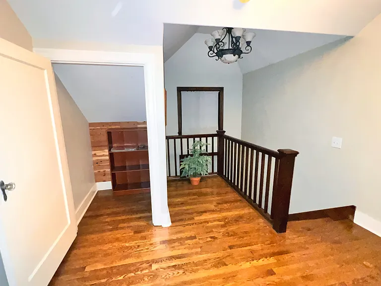 Up the stairs. Storage area with a door.