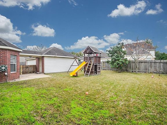 Spacious backyard with playset.