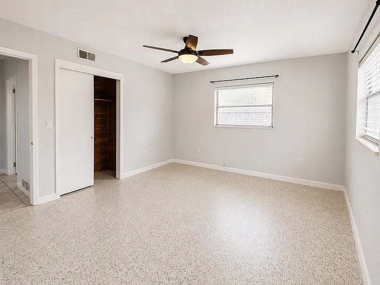 Bedroom #2 with one cedar closet and pocket door to Sunroom. Terazzo floors.